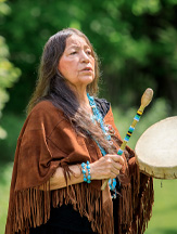 Mary Lou Smoke, playing hand drum